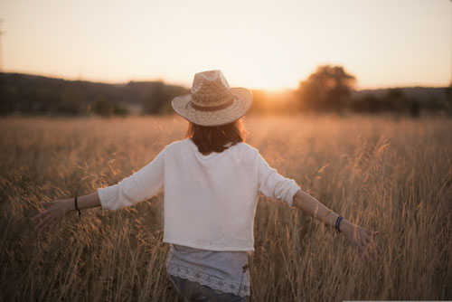 Women walking through wheat field expressing emotional healing